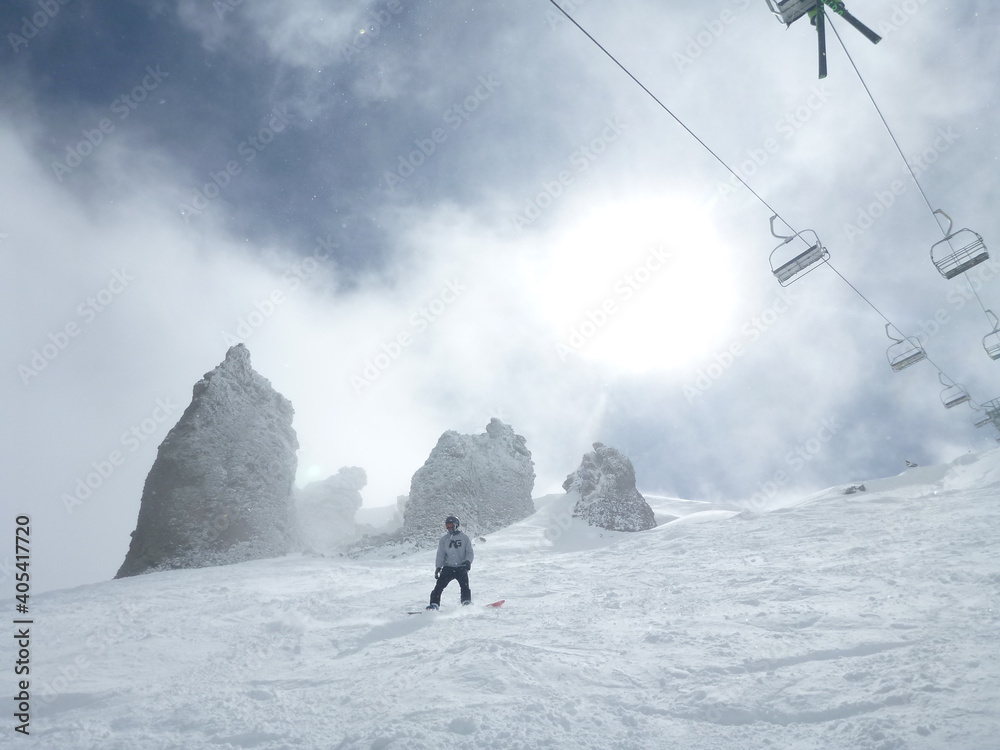 Moody view of the chair lift and extreme terrain at a ski resort in ...