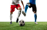 Fototapeta Sport - Close up legs of professional soccer, football players fighting for ball on field isolated on white background. Concept of action, motion, high tensioned emotion during game. Cropped image.