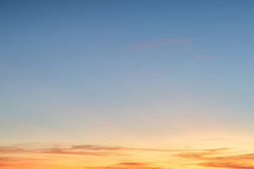 Heaven at early morning with copy space. Sunset, sunrise backdrop.Predawn clear sky with orange horizon and blue atmosphere. Smooth orange blue gradient of dawn sky.