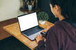 © panitan - computer screen blank mockup.hand woman work using laptop with white background for advertising,contact business search information on desk at coffee shop.marketing and creative design