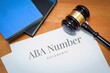 ABA Number. Document with label. Desk with books and judges gavel in a lawyer's office.