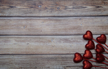 Poster - Top view of glitter hearts on stick with copy space on wooden table - perfect for wallpaper