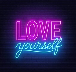 Love yourself neon quote on a brick wall. Inspirational glowing lettering.