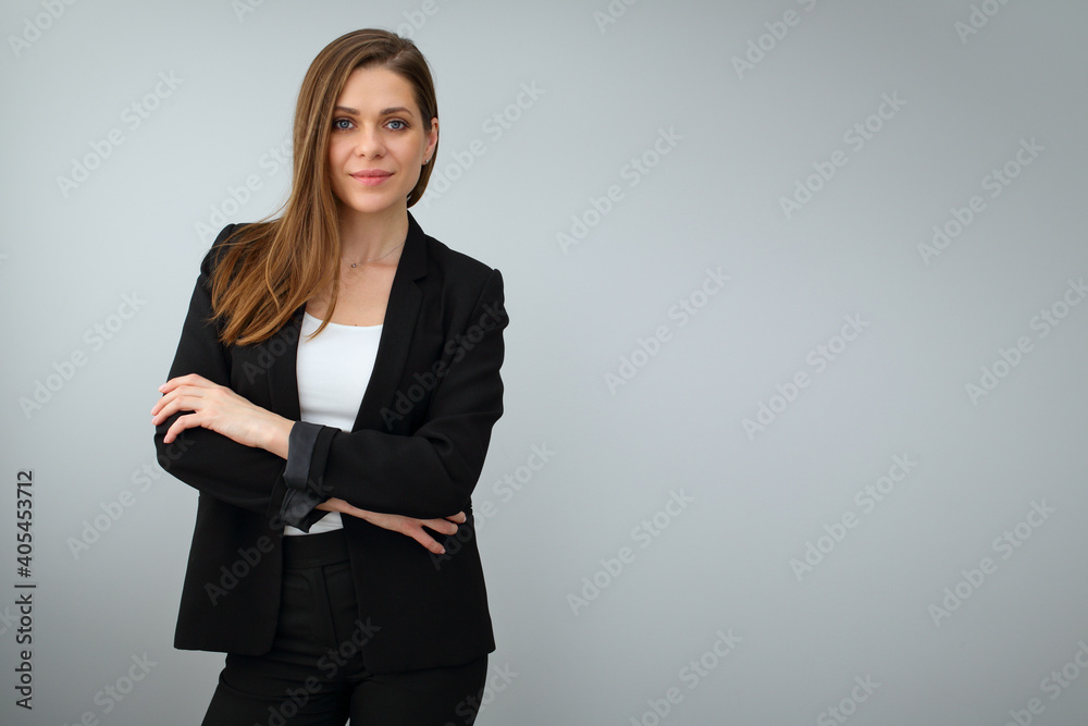 Smiling business woman wearing black suit standing with crossed arms ...