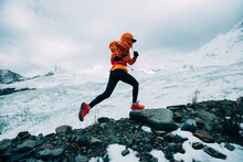 Woman Trail Runner Cross Country Running Up To Winter Snow Mountain Top