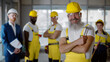 © nimito - Portrait of smiling aged foreman with construction team on background
