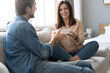 © opolja - Young woman receiving a surprise gift box from her boyfriend at home.