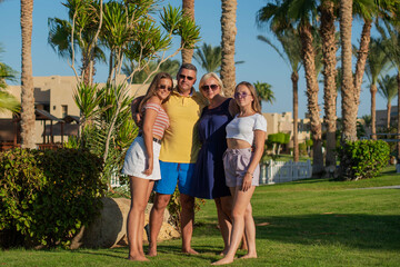 Wall Mural - Real people concept, beautiful family, two teenage girls, mother and father happiness and nice body for enjoyed people live an lifestyle, smile and walk together in vacation.