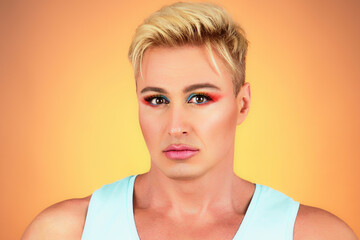 Wall Mural - Beauty Fashion guy with Colorful Art Makeup, Blonde Hair. Sexy man with Bright make up portrait. Handsome gay, healthy male skin, lgbtq concept. Fashionable trendy style