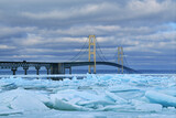 Fototapeta Do pokoju - Winter landscape of blue ice shards and the Mackinac Bridge, Straits of Mackinac, Lake Michigan, Michigan, USA