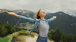 Travel image woman enjoying fresh air mountains raising her hands up on a Andorra background