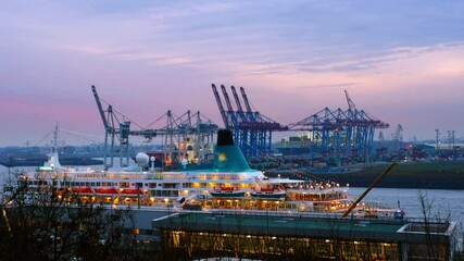 Wall Mural - Hamburg, Germany. Port of Hamburg on the river Elbe in Germany in the night. Huge touristic ships and industrial cranes with sunset colorful sky, zoom out