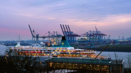 Wall Mural - Hamburg, Germany. Port of Hamburg on the river Elbe in Germany in the night. Huge touristic ships and industrial cranes with sunset colorful sky