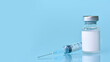© syhin_stas - Vaccine in a bottle with a syringe on a blue background.The concept of medicine, healthcare and science.Coronavirus vaccine.Copy space for text.Banner