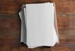 © New Africa - Stack of blank paper sheets on wooden background, top view