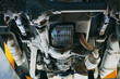 © SerPak - Bottom view of the car bottom. Diagnostics and repair of a vehicle in an auto repair shop. Detailed inspection