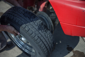 Canvas Print - Selective focus shot of a mechanic repairing a car wheel