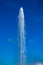 Water Jet From A Fountain In Abstract Design On Blue Sky Background. Urban Landscape.  Concept.