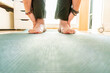 © Sergi - Feet of a man doing yoga on top of a mat