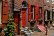 Philadelphia Street Scene In Historical Elfreth's Alley Section Of The City.  Showing Colonial Homes On A Cobblestone Street.