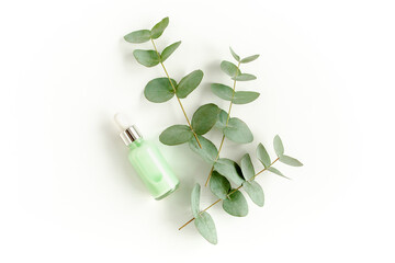 Wall Mural - Eucalyptus essential oil, eucalyptus leaves on white background. Natural, Organic cosmetics products. Medicinal plant. Natural Serums. Flat lay, top view.