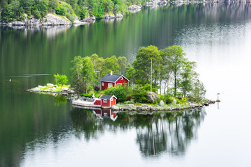 Wall Mural - breathtaking view of small island with red house in lovrafjorden fjord, norway. landscape photograph
