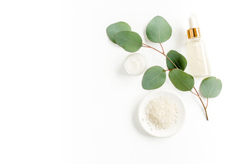 Wall Mural - Eucalyptus essential oil, eucalyptus leaves on white background. Natural, Organic cosmetics products. Medicinal plant. Natural Serums. Flat lay, top view.