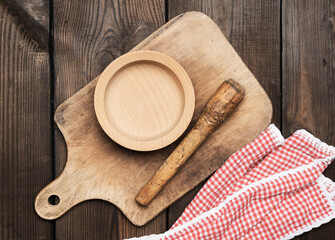 Wall Mural - empty plate and old brown rectangular wooden kitchen cutting board on the table