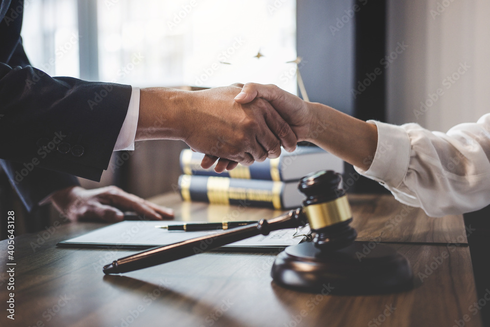 Close-up Of Lawyer And Customer Shaking Hands On Table - obrazy, fototapety, plakaty 