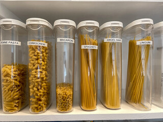 Wall Mural - An organized pantry shelf with various types of pasta