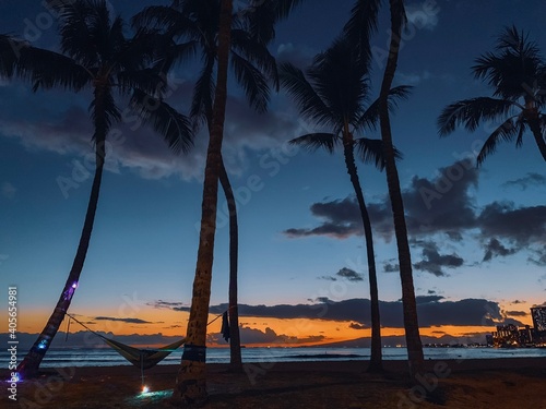 Obraz Dibond Silhouette Palm Trees On Beach Against Sky During Sunset