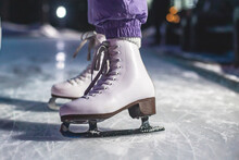 Close Up View Of New White Ice Skates Boots On Rink In Motion, Girl Ice Skating On Arena, Concept Of Ice Skating In Winter, Holiday Christmas Time