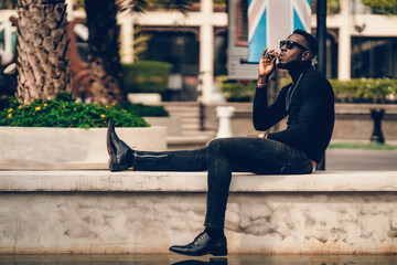 Wall Mural - portrait of african model smoking cigar and posing for photography