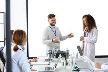 Poster - Team of doctors during meeting in modern clinic