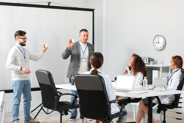 Poster - Team of doctors during meeting in modern clinic