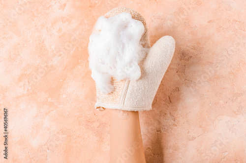 Obraz Dibond Female hand with massage glove on color background