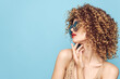 © SHOTPRIME STUDIO - Pretty woman With curly hair holds a hand near the face of red lips fashion style