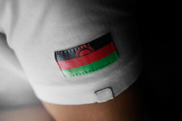 Patch of the national flag of the Malawi on a white t-shirt