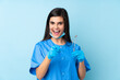 © luismolinero - Young woman dentist holding tools over isolated blue background points finger at you
