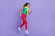 © deagreez - Full length body size view of pretty skinny cheerful wavy-haired girl jumping running isolated over violet pastel color background