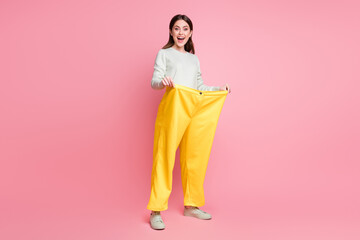 Canvas Print - Full body profile photo of astonished lady wear hands hold old funky large trousers open mouth isolated on pink color background