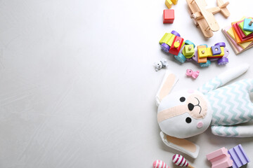 Wall Mural - Different toys on light background, flat lay. Space for text