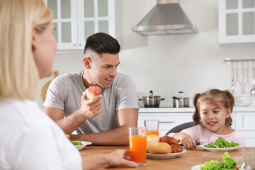 Sticker - Happy family having breakfast together at table in modern kitchen