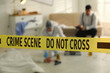 © New Africa - Investigators working at crime scene with dead body, focus on yellow tape