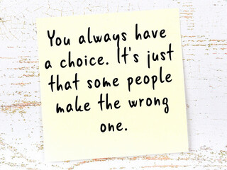 wise quote on sticky note on wooden wall