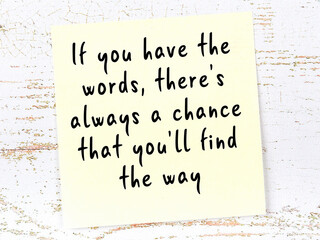 yellow sticky note on wooden wall with wise quote