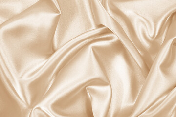 beige / light brown silk satin background. soft wavy folds in the fabric. wedding, anniversary, vale