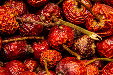 Dried herbs Red rosehip with tails. High concentration of vitamin C, pharmaceutical herb, vitamin tea. macro shooting