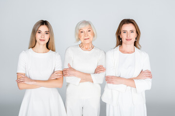 Sticker - three generation of women standing with crossed arms isolated on grey