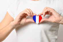 Love France. A Girl Holds A Heart In The Form Of A Flag Of France On Her Chest. French Patriotism Concept